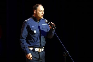 Umundurowany policjant przemawia na scenie