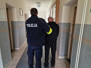 Zdjęcie przedstawia umundurowanego policjanta z zatrzymanym mężczyzną.