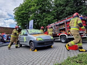 Zdjęcie przedstawia: strażaków podczas symulacji wypadku samochodowego