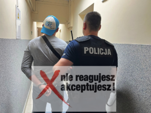 Zdjęcie przedstawia umundurowanego policjanta wraz z zatrzymanym mężczyzną, który ma założone kajdanki na ręce.