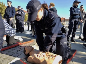 Na zdjęciu umundurowana policjantka ćwicząca prowadzenie resuscytację na fantomie