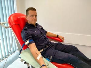 Zdjęcie przedstawia policjanta oddającego krew.