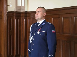 Zdjęcie przedstawia: umundurowanego policjanta.