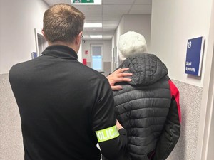 Policjant z zatrzymanym na zdjęciu.